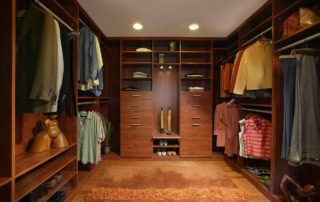 This his/hers walk-in closet provides plenty of room to prevent crowding. Stain grade casework in this closet maintains the naturally rich theme throughout the house. The recessed lighting provides wonderful lighting above the engineered maple floor.