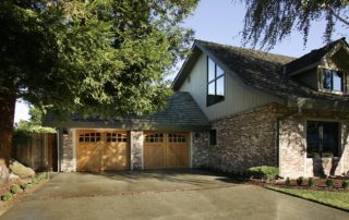 Stain grade carriage style doors provided by the client add true beauty to this garage.